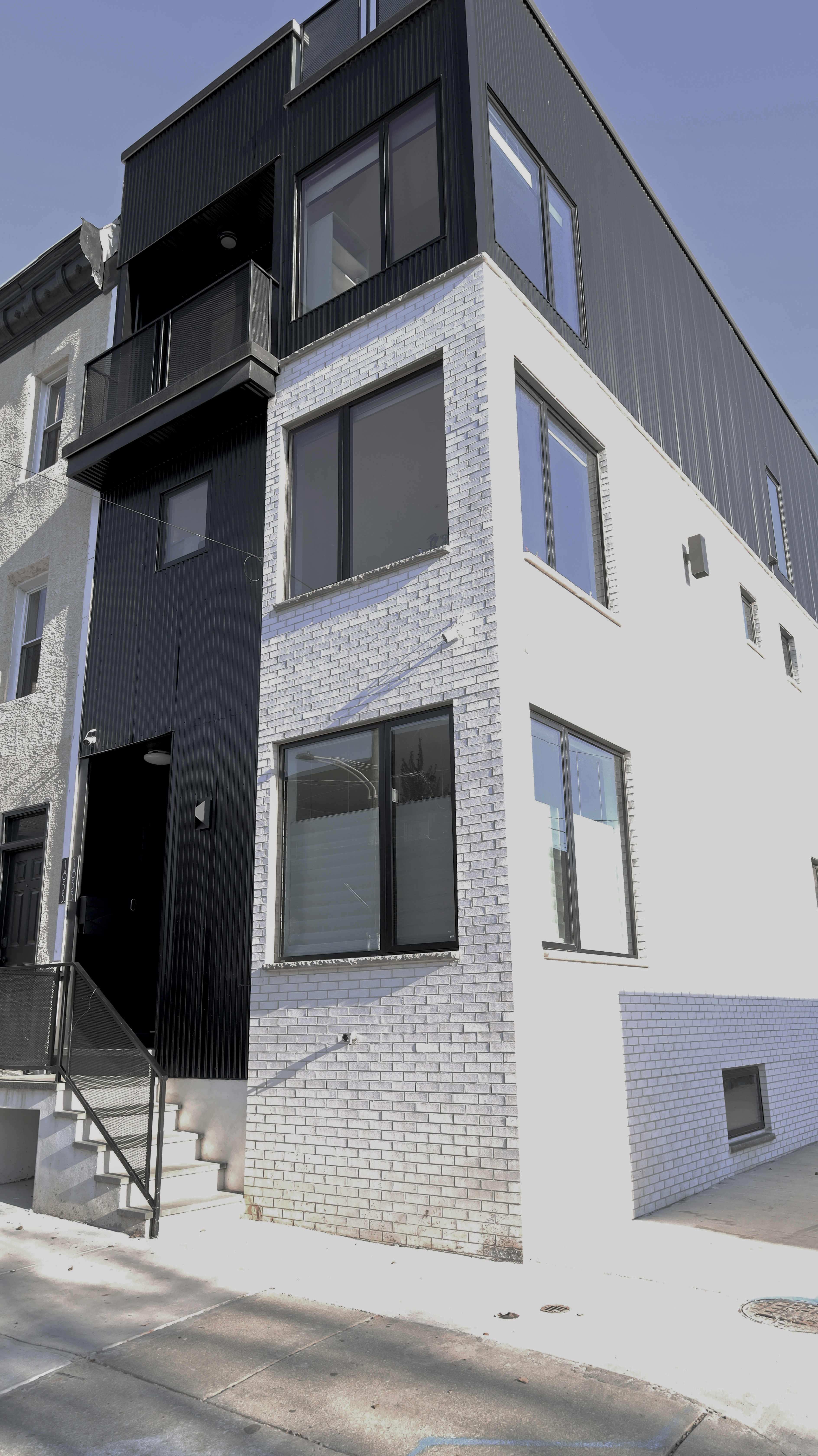 Dark modern facade of the ground-up custom home in East Kensington