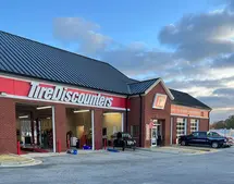 Renovated Tire Discounters showroom in Kennesaw with epoxy flooring, painted walls, and updated lighting.
