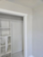 White built-in closet shelving within a doorway.