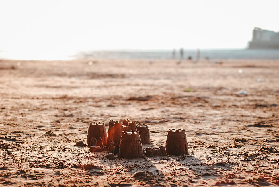 Little sandcastles on a golden midday beach, by Hello I'm Nik.