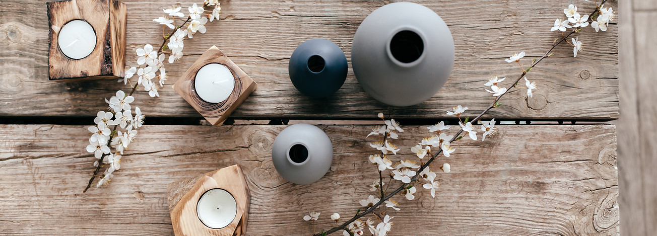 Scandanavian vibe with unique vases and candles on a reclaimed wood tabletop