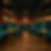 Basement as a luxurious lounge with teal velvet seating, gold tables, and dim lighting. Wooden floor and red curtains create a cozy, elegant atmosphere.