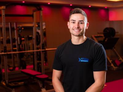 Man smiling in front of gym 