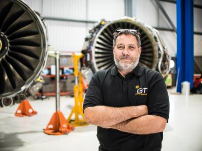 man standing in front of airplane engine