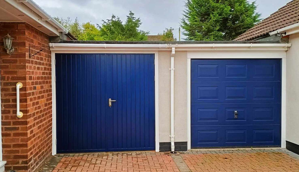 Blue garage doors on drive way with white surround.