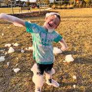 child covered in foam and a big smile
