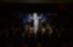 Beetlejuice performer in striped suit on a theatrical stage
