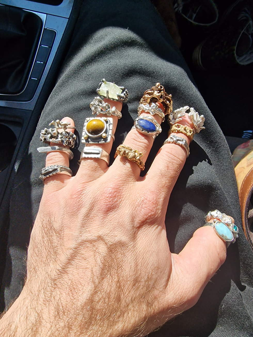 a hand with a lot of rings on it