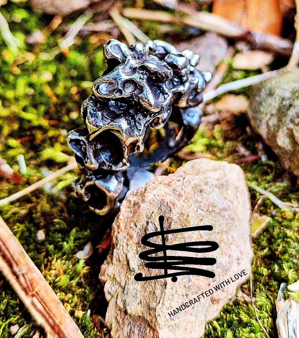 a handcrafted with love logo is on a rock