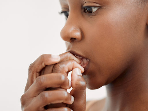 young girl chews on skin around her nails
