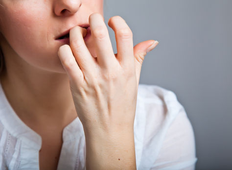Woman chews on skin around fingernails