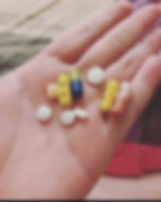 Palm of hand outstretched holding 9 various medications
