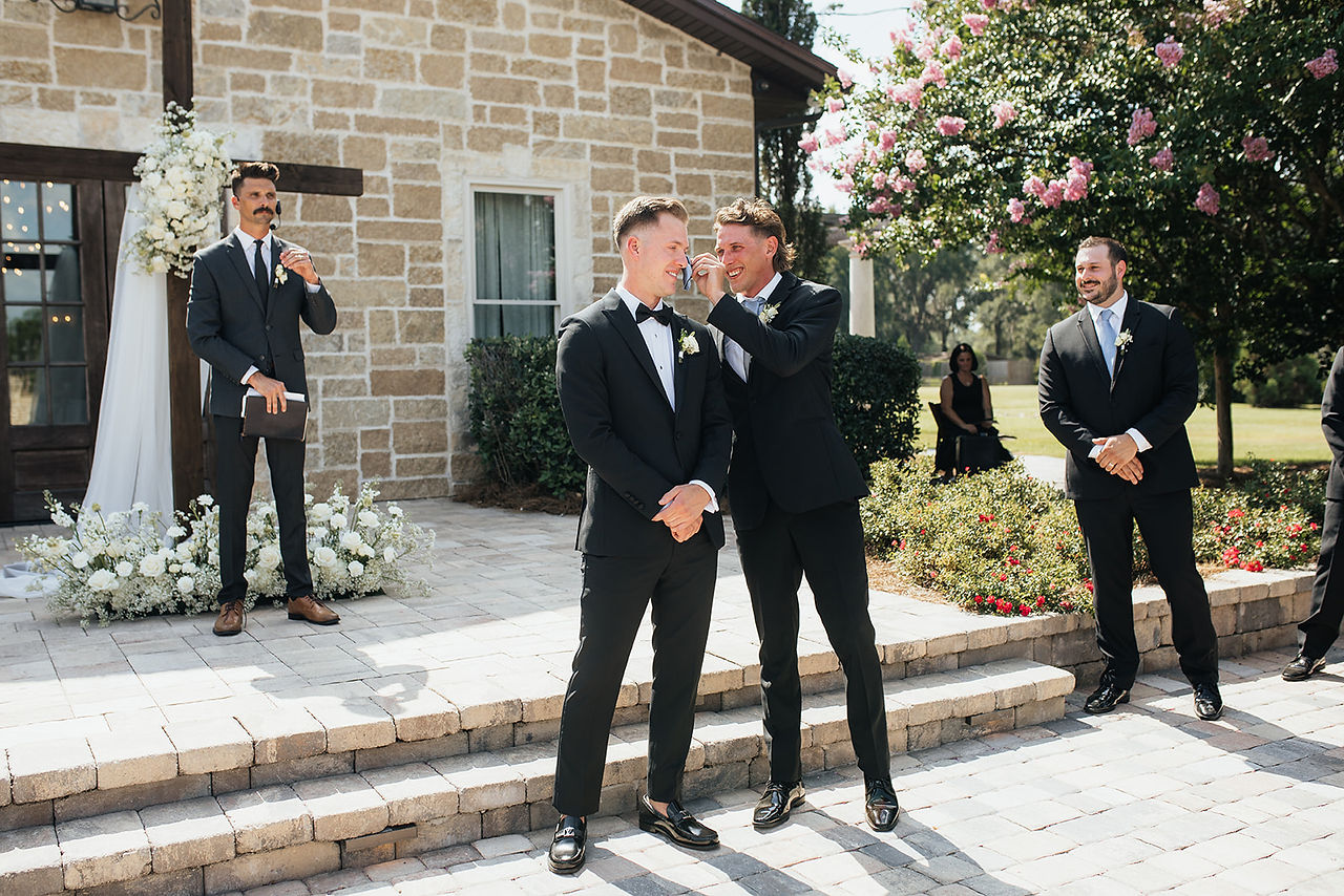 Groom wiping tears during emotional first look with bride at North Florida wedding