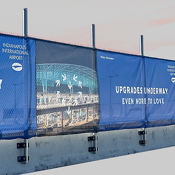 Blue mesh banner for the Indianapolis International Airport on a fence.