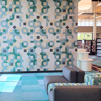 Pattern sampled from a chair cushion applied as a wall covering in a lounge space.