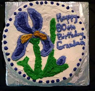 Double Layered 9 Inch Round Cake with Whipped Icing and decorated with an Iris