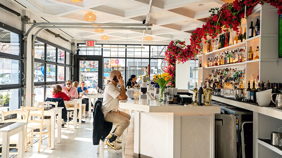 Close-up view of a signature Greek cocktail garnished with fresh herbs and citrus
