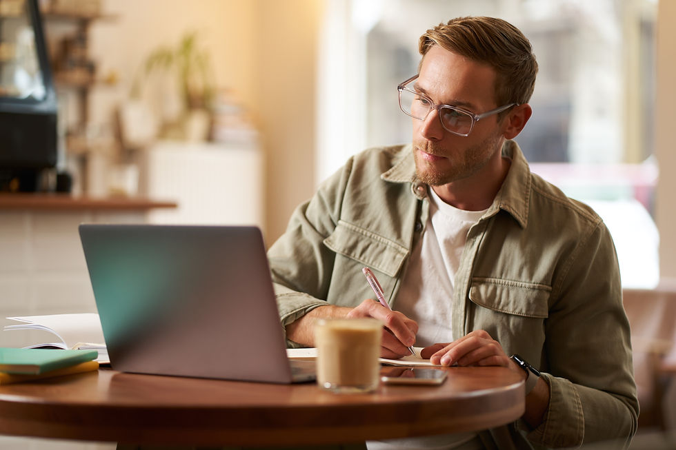portrait-handsome-young-guy-glasses-man-studying-taking-notes-looking-laptop-screen (1).jp