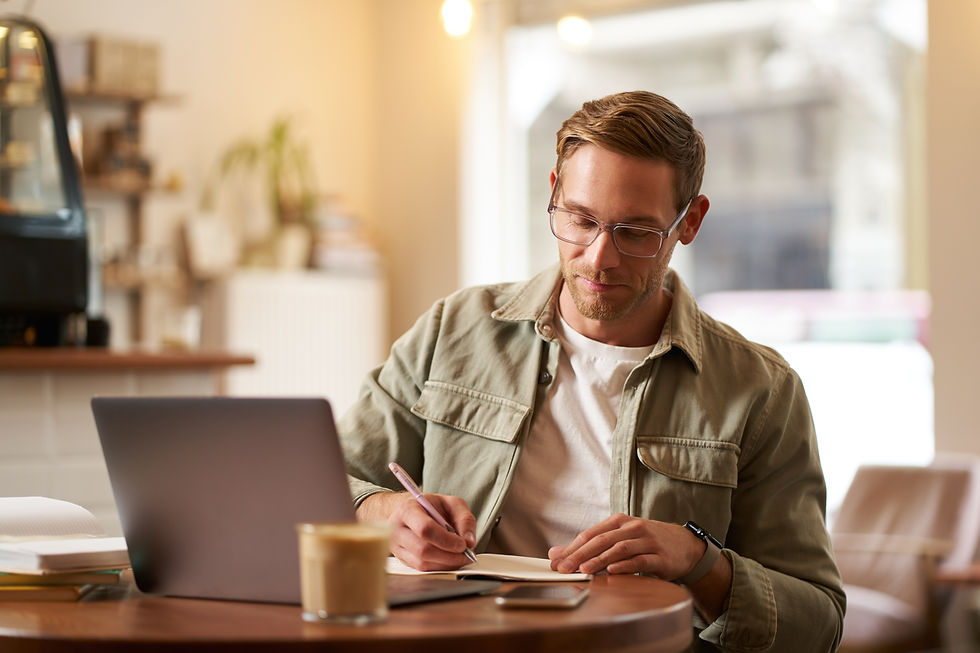 portrait-handsome-young-guy-glasses-man-studying-taking-notes-looking-laptop-screen.jpg