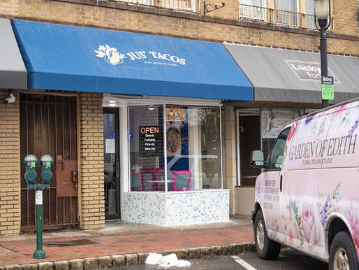 a picture of outside Jus' Tacos and the garden of Edith van