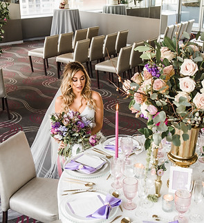 Bride seated at an elegantly styled wedding reception table