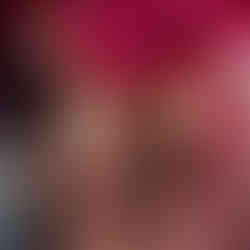 Close-up of bride’s hands showing intricate mehndi and red bridal bangles