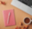 business strategy flatlay with pink notebok pen coffee and laptop