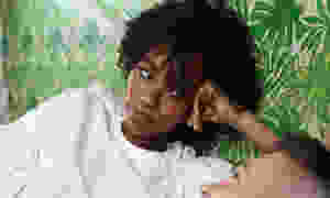 Black woman looking at white man in bed