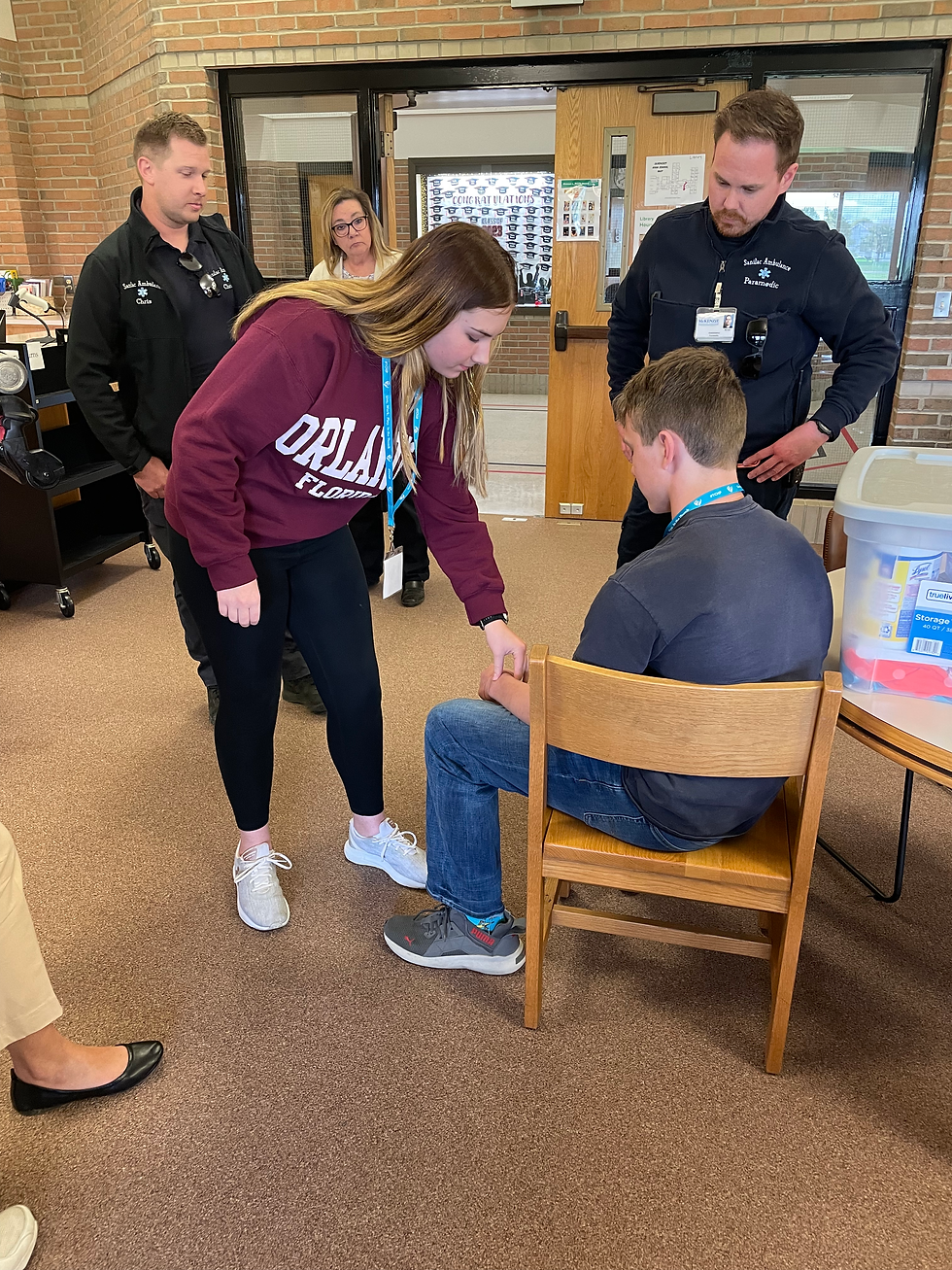 Students taking each others pulse.