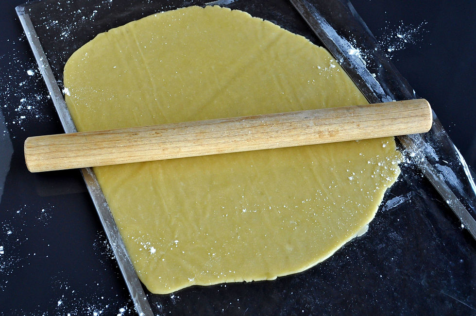Estirando la masa de tarta entre varillas para que quede de un grosor parejo.