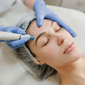Close-up of a woman receiving a non-invasive facial treatment — representing medical aesthetics services at Bilgrien Health.