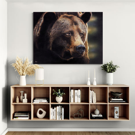 ‘Out of Darkness,’ bear canvas displayed above a floating bookshelf with books, vases, and decor.