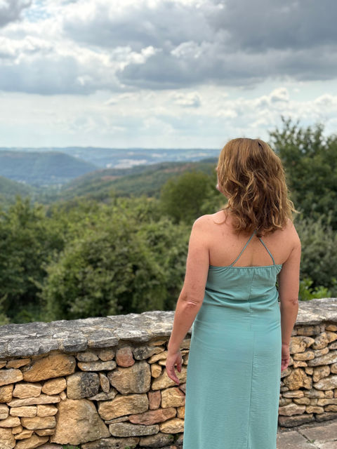 Woman peacefully enjoying the scenic Dordogne countryside.