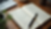 High angle view of a journal and pen on a wooden table, symbolizing self-reflection and personal growth