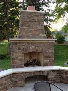 Tiered stone fireplace with bottom wood storage