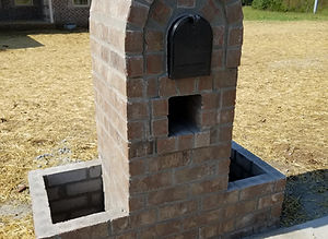 Round brick mailbox with planters