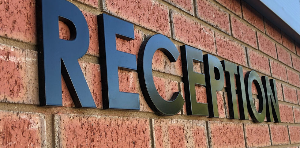 Mounded 3D letters fixed on outdoor wall of warehouse premises to guide clients to Reception