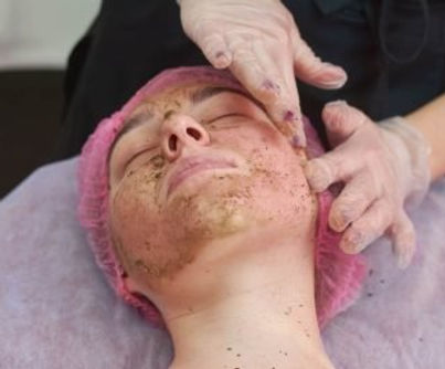 Hands applying coral face peel..jpg
