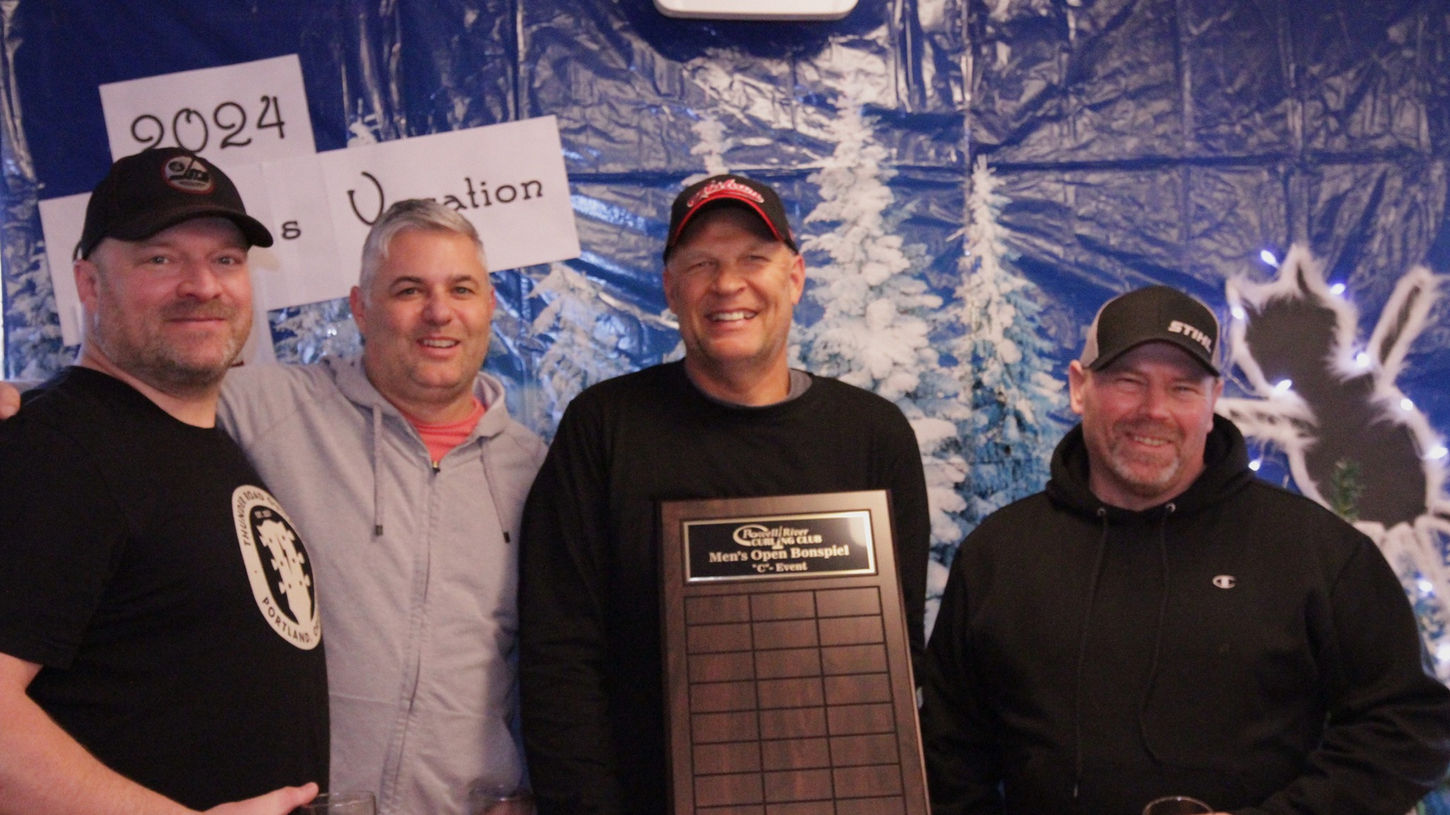 Group of men holding a plaque, smiling for a pic