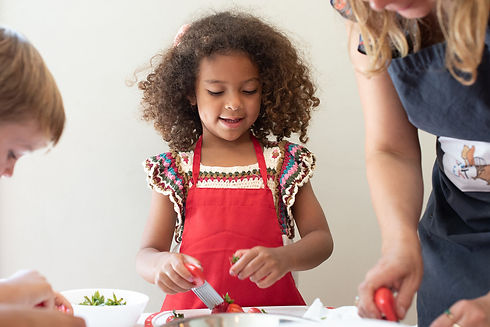 Girl cutting strawberries