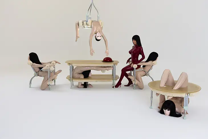 BIO POP performance installation by Bianca Censori, featuring contortionists embedded into chairs and tables as living furniture. Domenech Concept