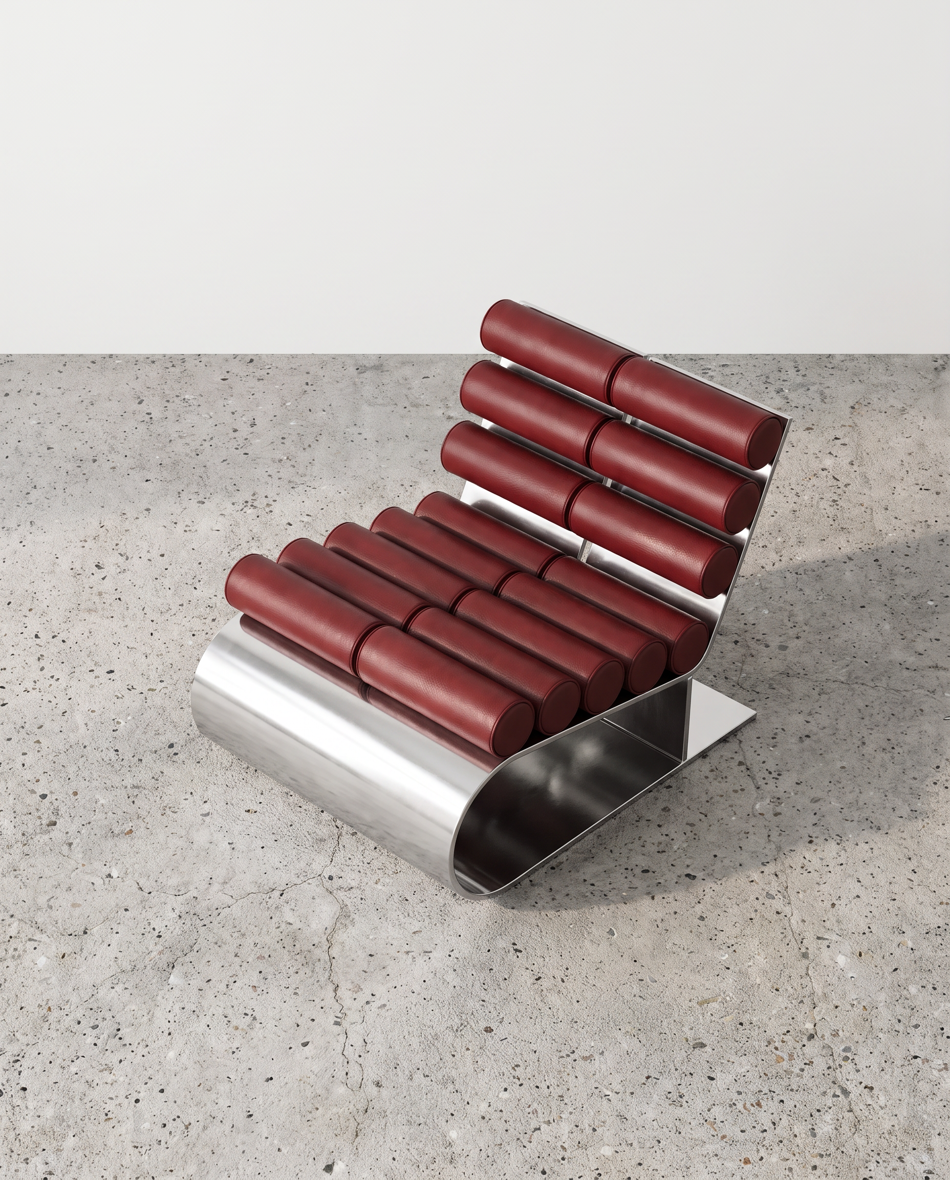 aluminum-lounge-chair-burgundy-leather-bolster-three-quarter-view.png
