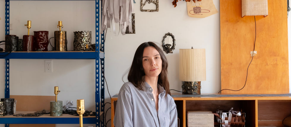Ceramic artist Bianca Augustine with her handcrafted lighting collection at Augustine Ceramics, featuring sculptural lamps, candle holders, and artisan home décor.