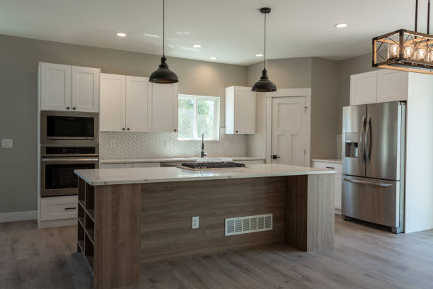 A well-designed kitchen with a table and chairs, representing the expertise of a kitchen renovation company.