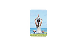 Woman meditating in yoga pose by the ocean