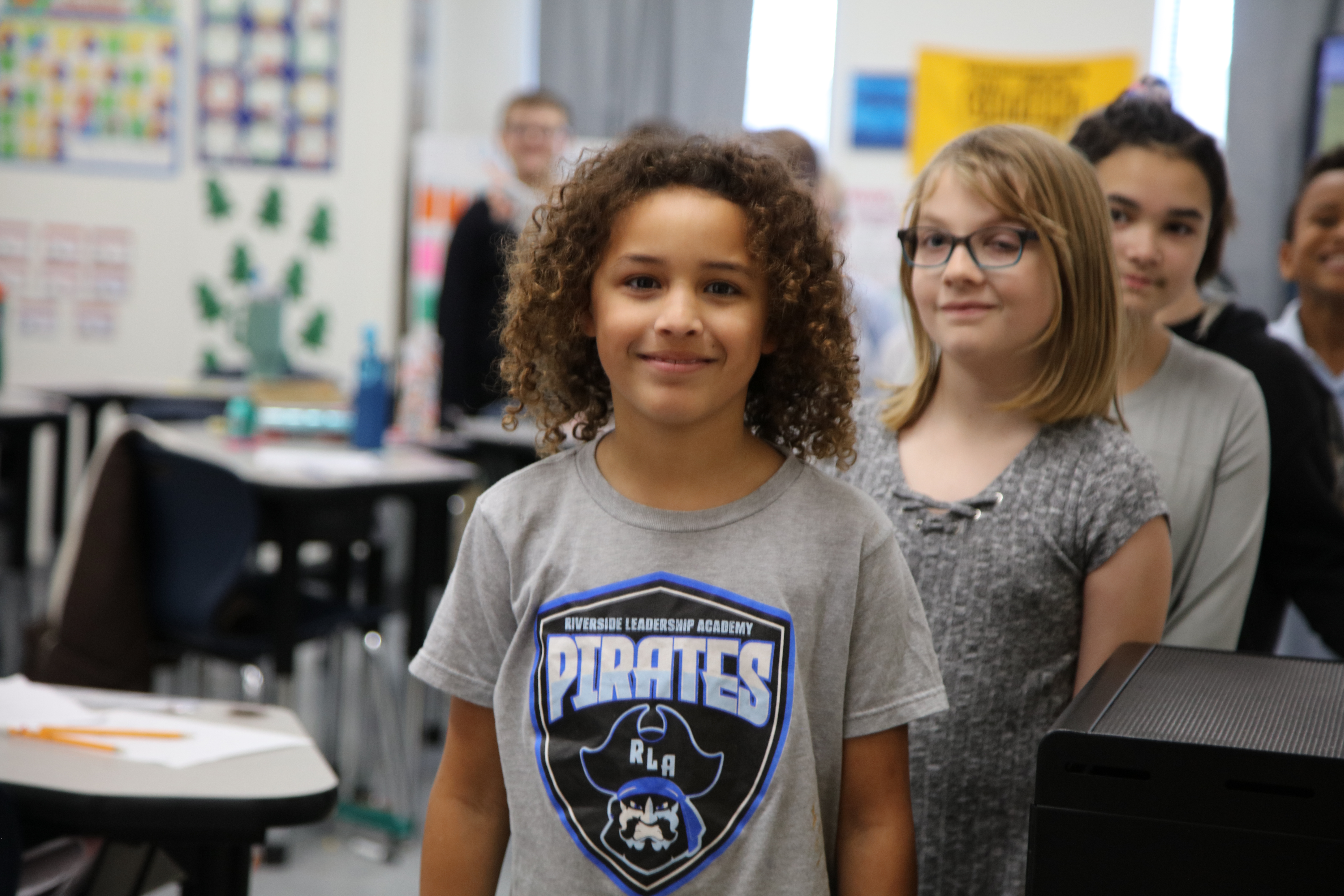 student smiling wearing a RLA brand shirt