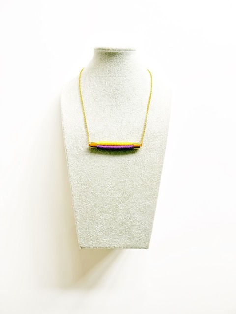 Thumbnail: model wearing colourful rope statement necklace with casual outfit