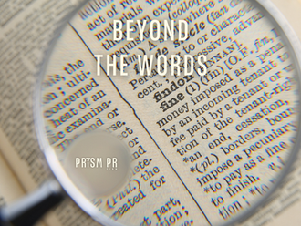 Magnifying glass focusing on printed words, illustrating how language influences perception and understanding.