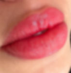 Close-up of soft pink lips showing natural enhancement and smooth texture