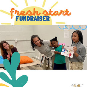 CEO, Jennie Lobato, conducting show and tell with 2 young artists. Happy volunteer smiles and claps.